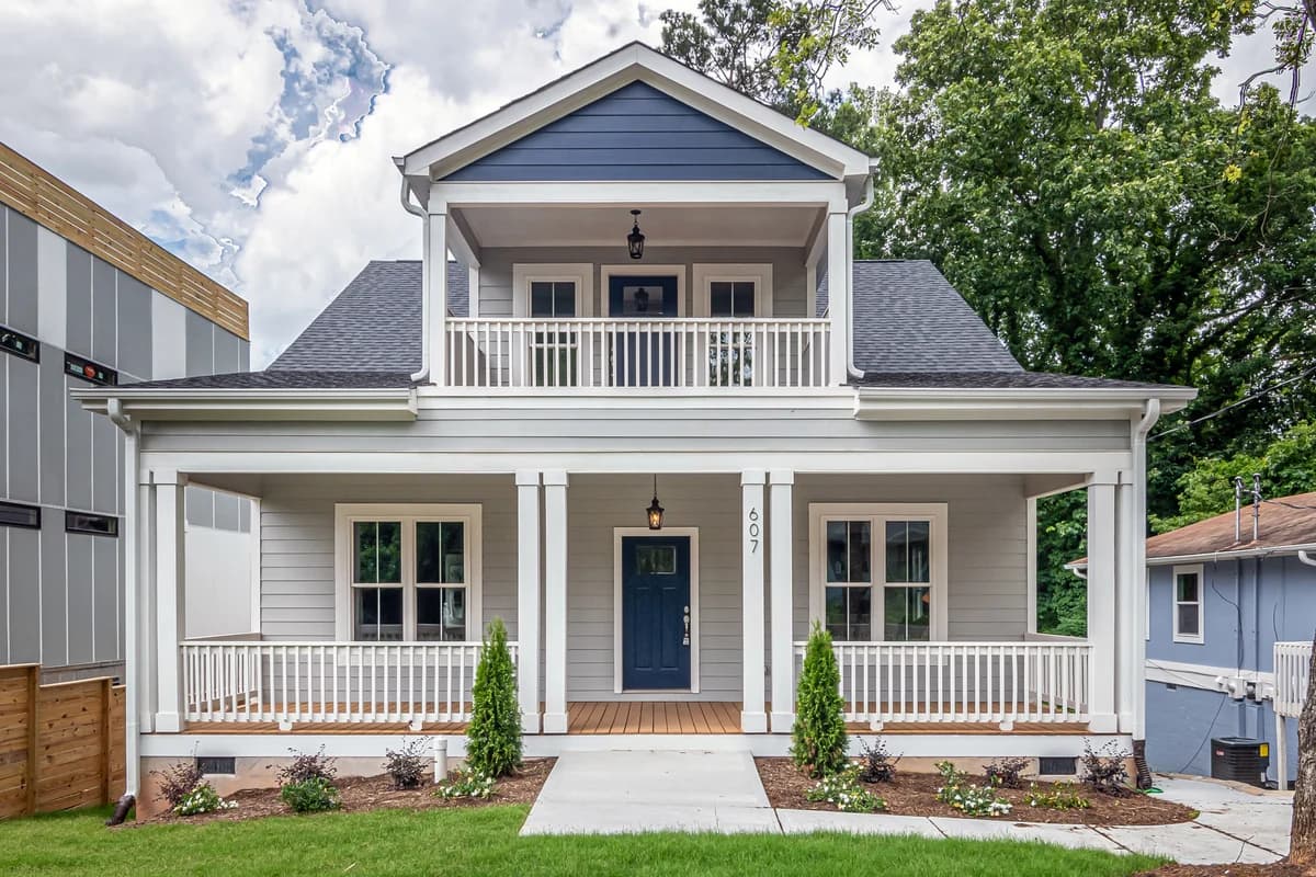 Two-story house with a covered front porch, walkway and planted front yard